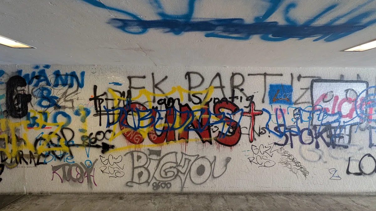 Sprayereien in einer schmuddeligen Unterführung.